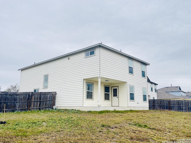 rear view of house with a yard