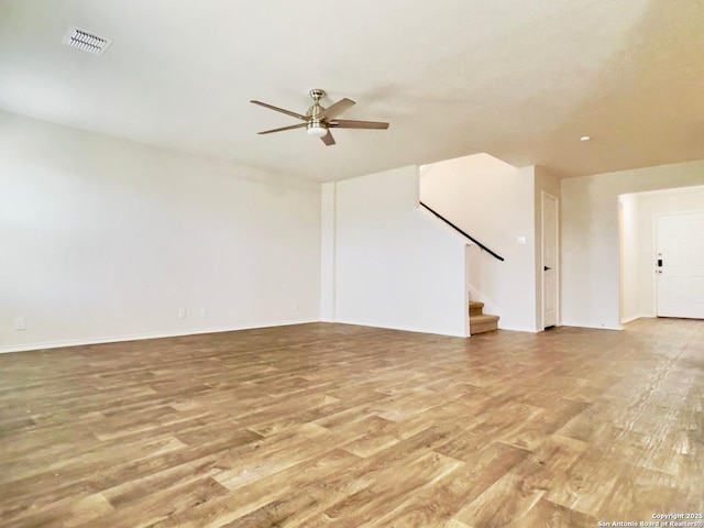 unfurnished living room featuring ceiling fan and light wood-type flooring