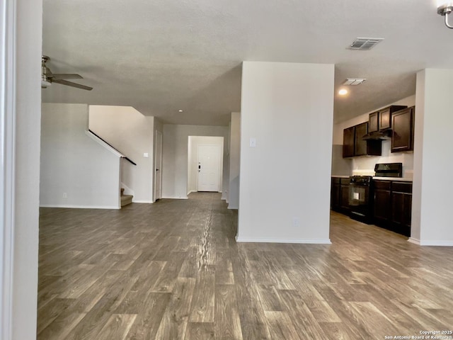 unfurnished living room featuring hardwood / wood-style flooring and ceiling fan