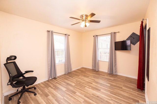 unfurnished office with ceiling fan and light hardwood / wood-style flooring