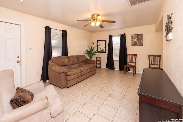 tiled living room with ceiling fan