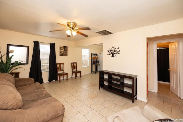 living room featuring ceiling fan and light tile patterned floors