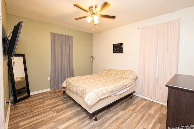 bedroom featuring light hardwood / wood-style flooring and ceiling fan