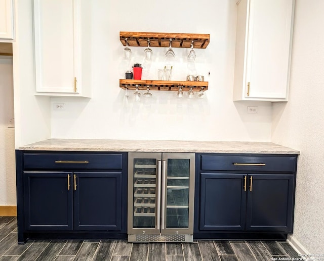 bar featuring white cabinetry, wine cooler, and blue cabinets