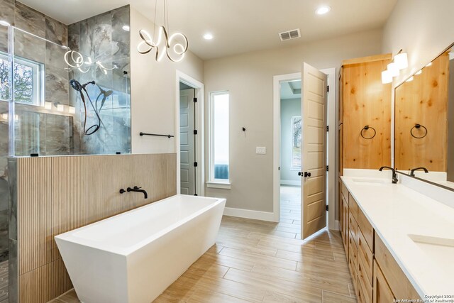 bathroom with vanity, hardwood / wood-style flooring, and independent shower and bath