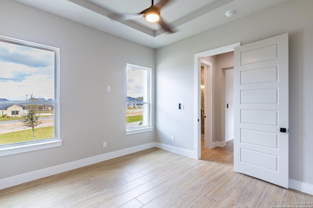 empty room featuring ceiling fan and light hardwood / wood-style flooring