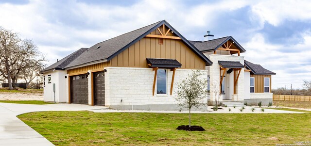 view of front of property with a front yard and a garage