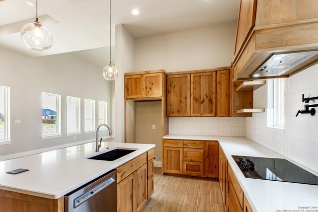 kitchen featuring sink, hanging light fixtures, tasteful backsplash, stainless steel dishwasher, and black electric cooktop