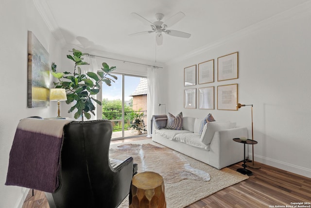 living room with ceiling fan, crown molding, baseboards, and wood finished floors