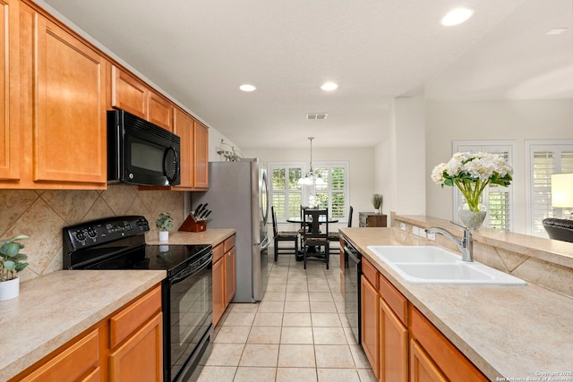 kitchen with backsplash, black appliances, sink, hanging light fixtures, and light tile patterned flooring