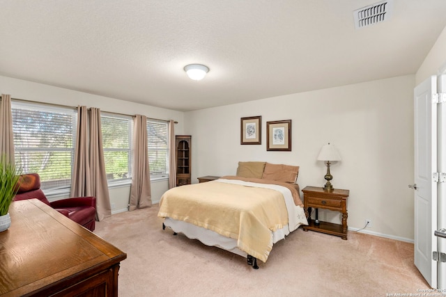 carpeted bedroom with a textured ceiling