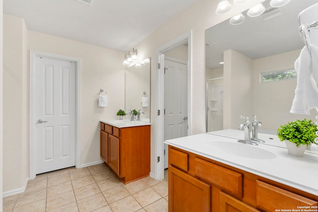 bathroom with tile patterned floors, vanity, and walk in shower