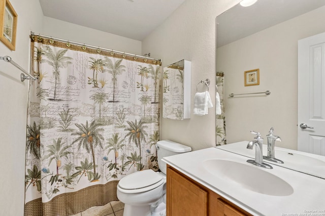 bathroom with tile patterned floors, vanity, and toilet