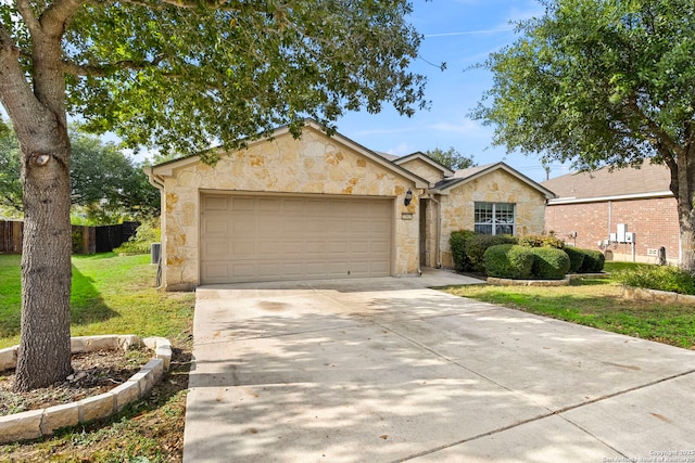 ranch-style home featuring a front lawn and a garage