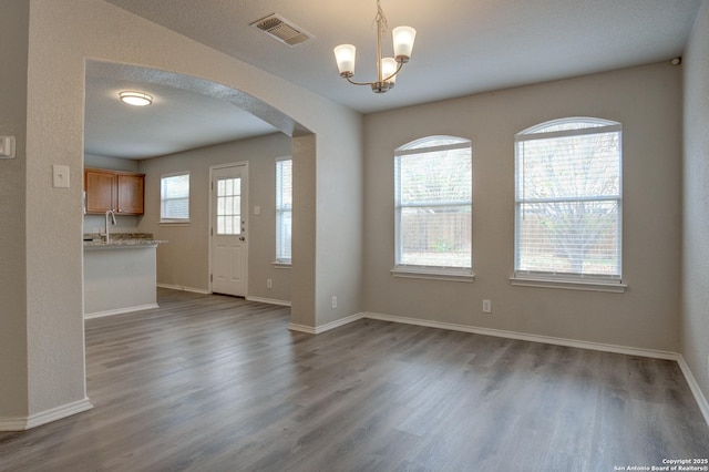 foyer featuring a chandelier and dark hardwood / wood-style floors