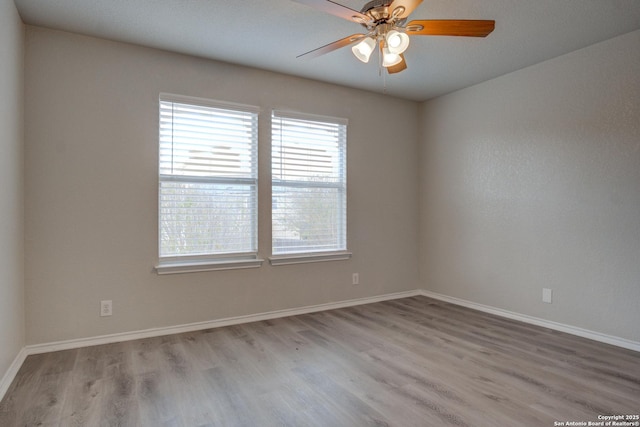 unfurnished room featuring light hardwood / wood-style floors and ceiling fan