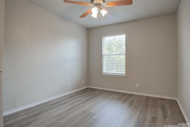 unfurnished room featuring ceiling fan and light hardwood / wood-style flooring