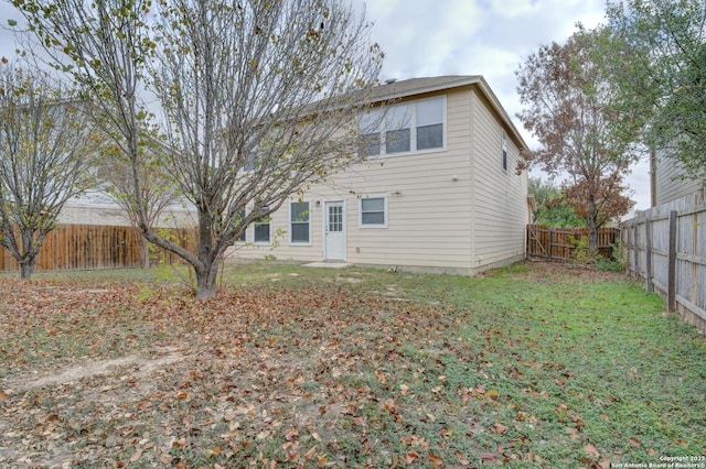 rear view of house with a yard