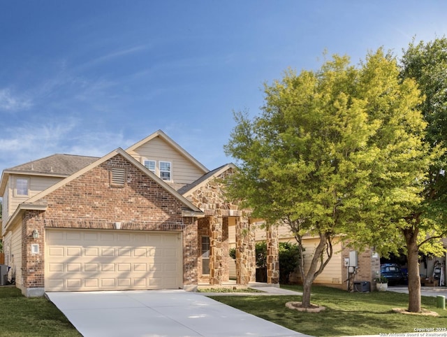 view of front of property featuring a front yard, a garage, and cooling unit