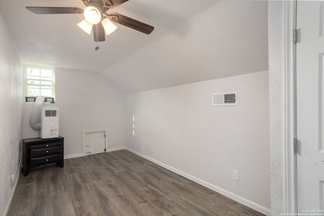 additional living space with hardwood / wood-style floors, ceiling fan, and vaulted ceiling