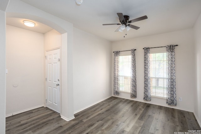 empty room featuring dark hardwood / wood-style floors and ceiling fan