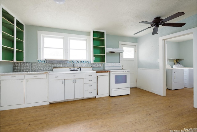 kitchen featuring white range, light hardwood / wood-style flooring, separate washer and dryer, white cabinetry, and extractor fan