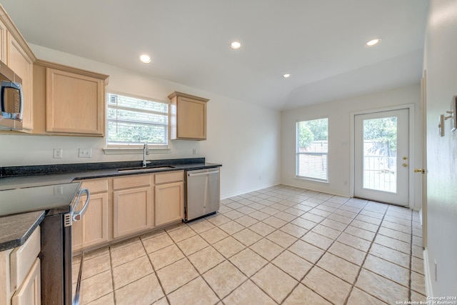 kitchen with light brown cabinetry, sink, light tile patterned floors, and stainless steel appliances