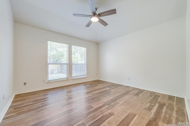 empty room with ceiling fan and wood-type flooring