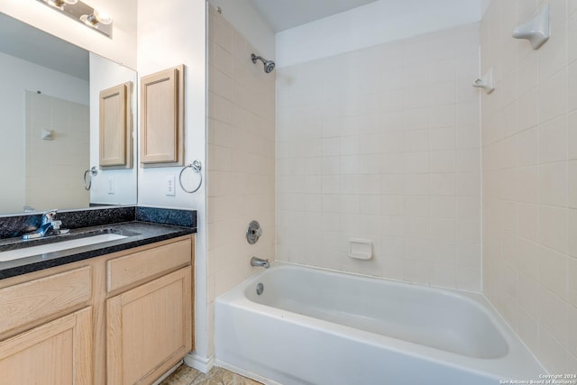 bathroom featuring vanity and tiled shower / bath combo