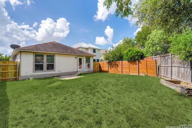 back of house with a lawn