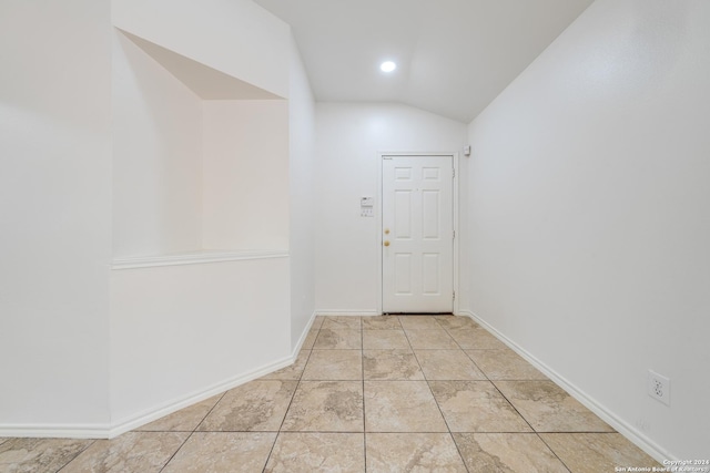 hallway featuring vaulted ceiling