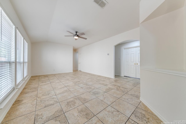 spare room with ceiling fan, a healthy amount of sunlight, and light tile patterned floors