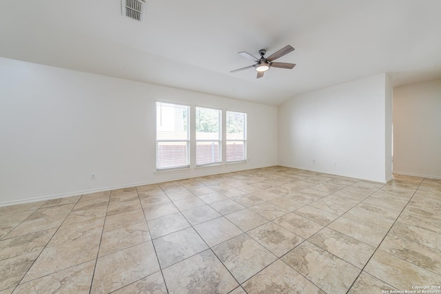 tiled spare room featuring ceiling fan and lofted ceiling