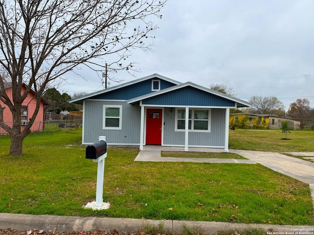 bungalow-style house with a front lawn