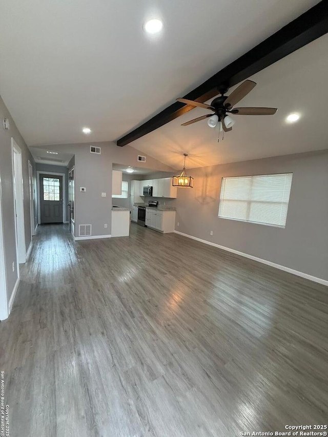 unfurnished living room featuring lofted ceiling with beams, dark wood-type flooring, and ceiling fan with notable chandelier