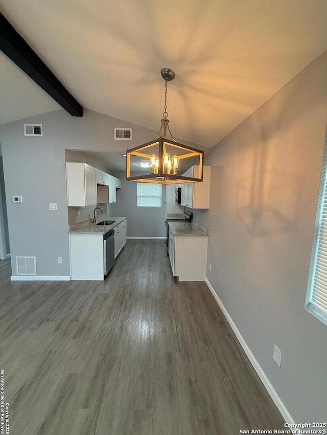 kitchen featuring white cabinets, dark hardwood / wood-style floors, appliances with stainless steel finishes, decorative light fixtures, and a chandelier