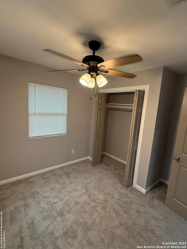 unfurnished bedroom with carpet floors, a closet, and ceiling fan