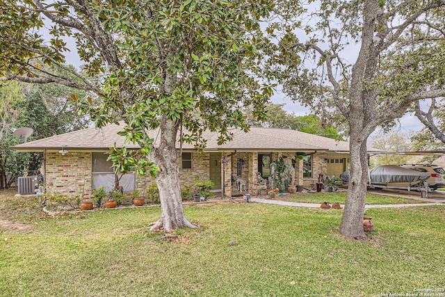 ranch-style house with a front yard and central air condition unit