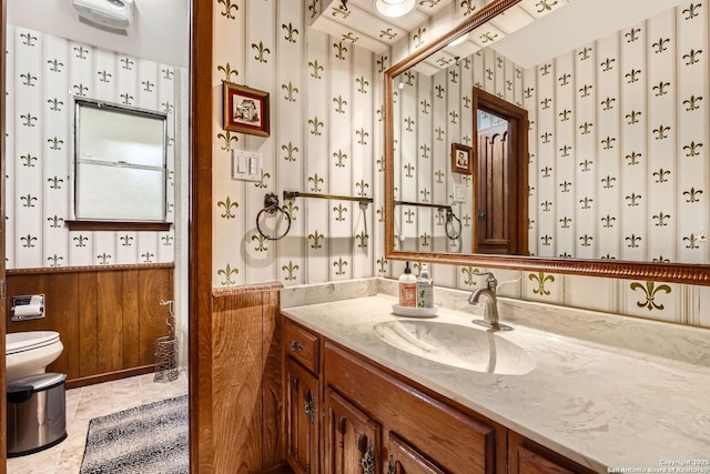 bathroom with tile patterned flooring, vanity, and toilet