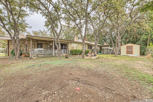 view of front of house featuring a porch and a shed