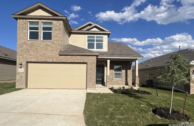 craftsman house with a front yard, a garage, and central AC unit