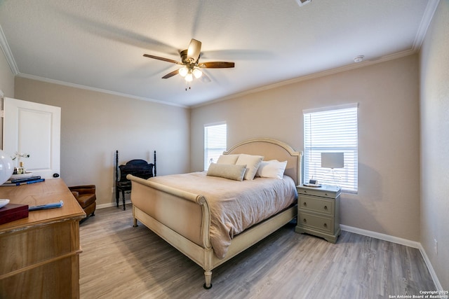 bedroom featuring ceiling fan, wood-type flooring, and ornamental molding