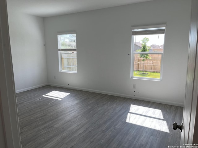 spare room with dark hardwood / wood-style flooring