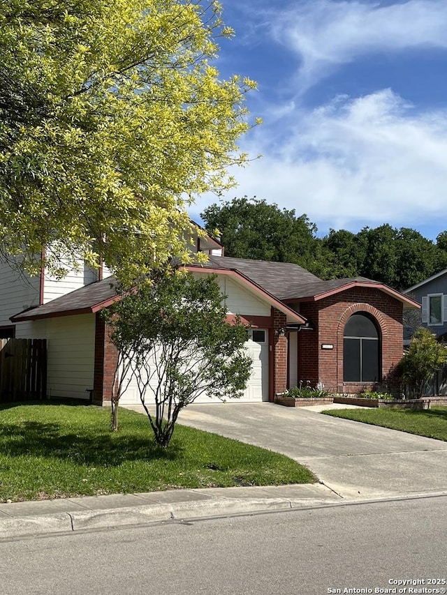 view of front of property featuring a front yard and a garage