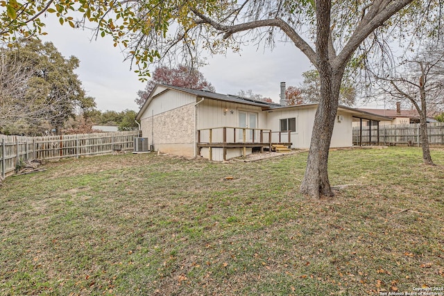 view of yard with a wooden deck and central AC