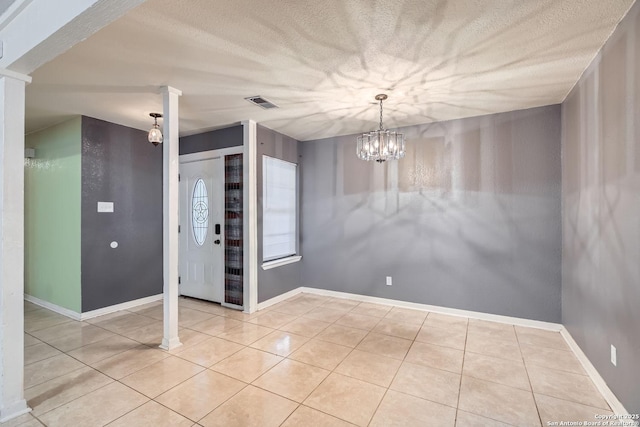 interior space featuring light tile patterned floors and a notable chandelier