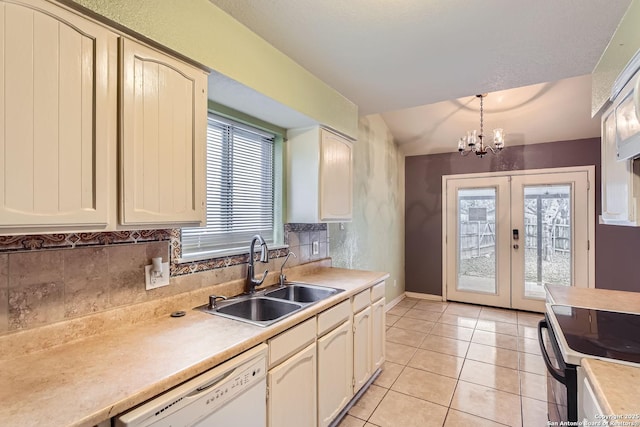 kitchen featuring french doors, white dishwasher, sink, a notable chandelier, and light tile patterned flooring