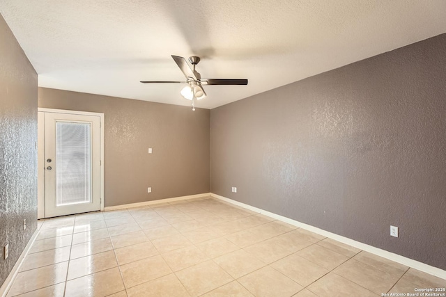 unfurnished room with light tile patterned floors, a textured ceiling, and ceiling fan