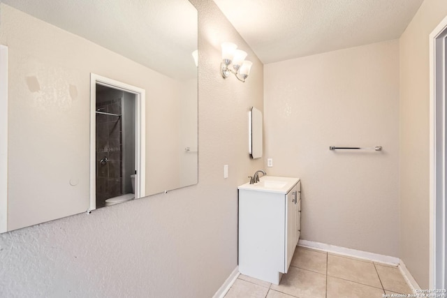 bathroom featuring tile patterned floors, vanity, a textured ceiling, and walk in shower