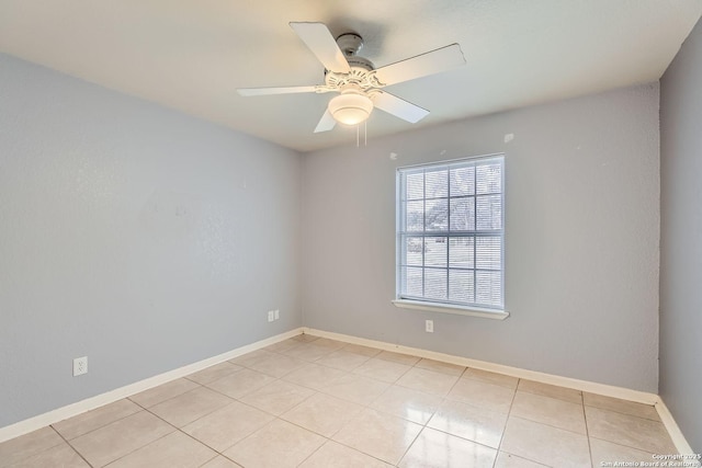 spare room featuring ceiling fan and light tile patterned floors